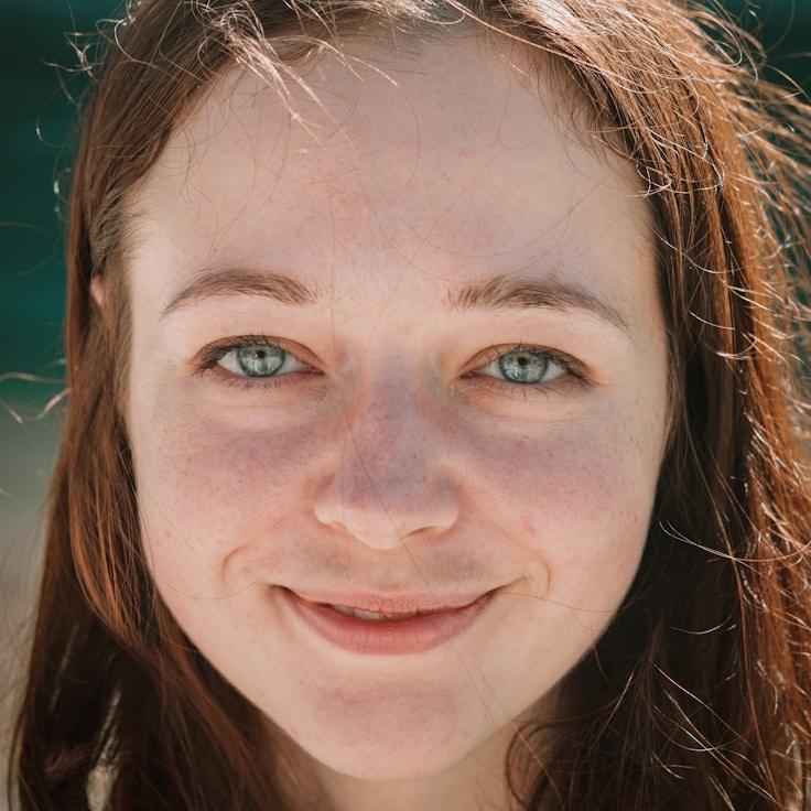 Avery Kim, Lead Design Curator at EarthBenchWorks, reviewing corporate floral arrangements